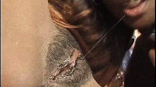 Three beautiful ebony babes fuck in bed with a strap-on